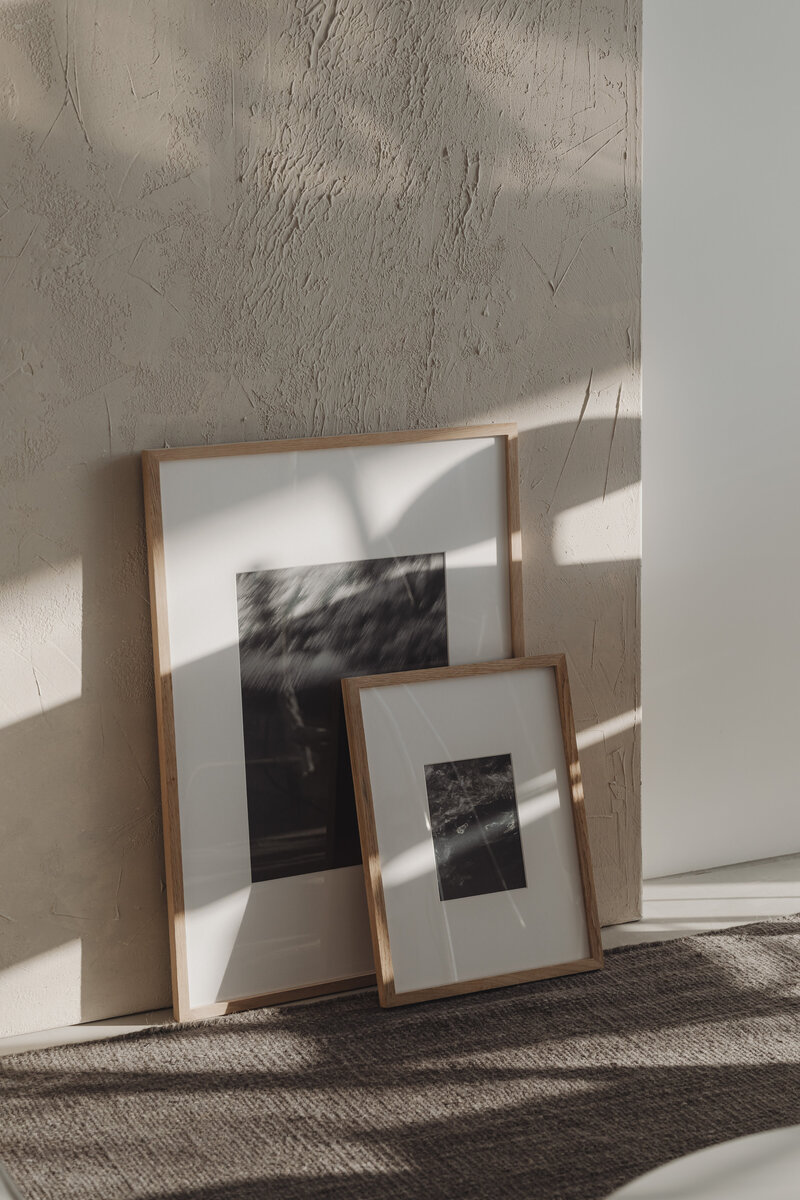 kaboompics_two-framed-pictures-leaning-against-a-textured-wall-36963