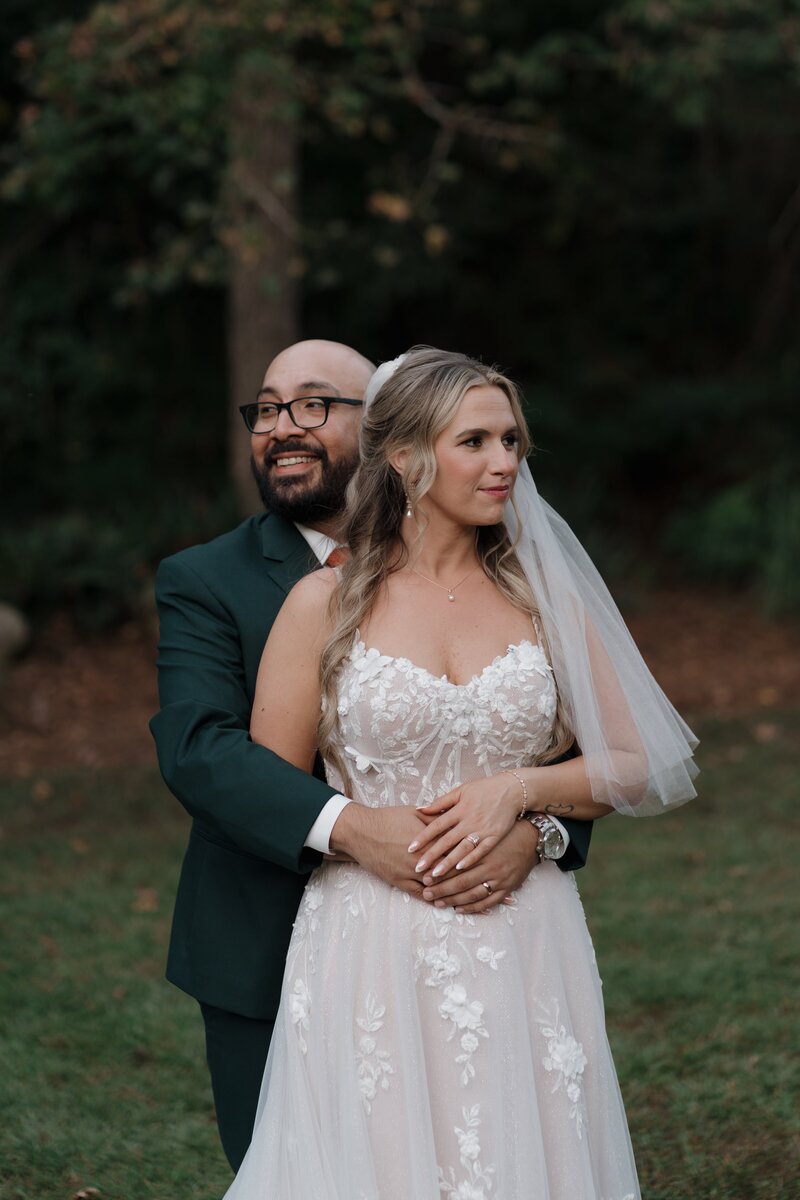 Bride and groom embracing each other at Vecoma at the Yellow River near Stone Mountain.