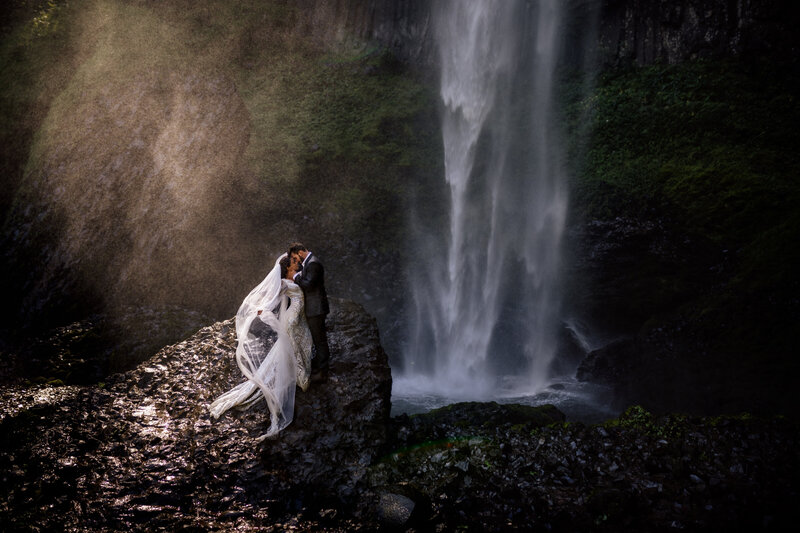 A captivating bridal portrait set against the dramatic backdrop of a Pacific Northwest cave, perfect for adventurous souls.