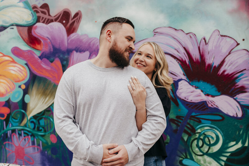 engagement photos by colorful mural in savannah