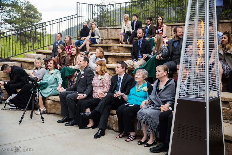 Wedding guests seated in the outdoor amphitheater at Della Terra with heaters