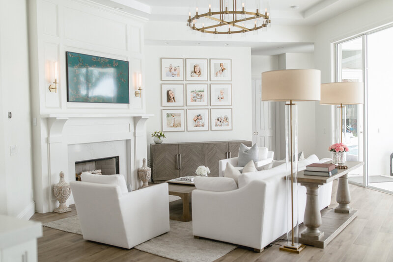 High end luxury home living room with heirloom gallery wall of family portraits