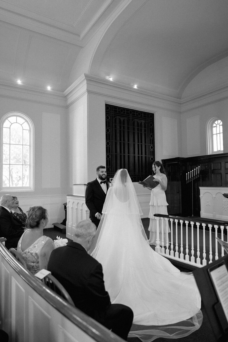 Bride and groom during their wedding ceremony inside the historic Martha-Mary Chapel at Greenfield Village in Dearborn, Michigan.
