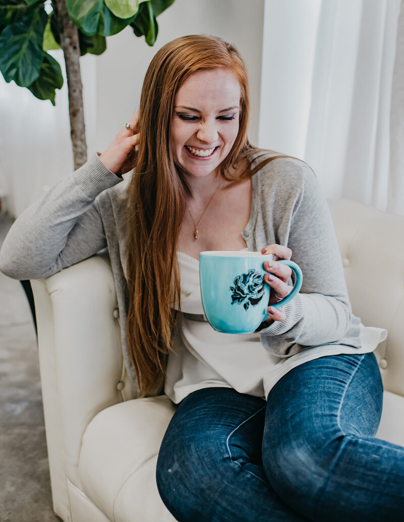 hoffman-creative-co-graphic-designer-maggie-holding-tea-cup-couch