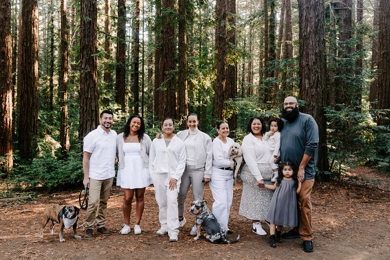 family portrait with dogs in the forest