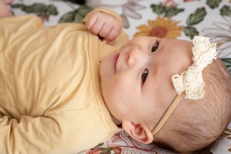 A close-up of a baby girl smiling during her photography session in Manassas, VA.