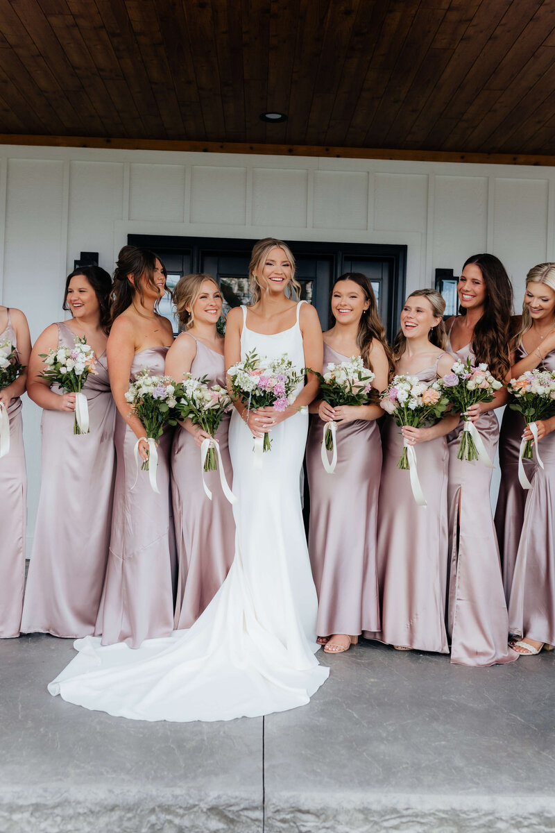 Bridal party in blush satin dresses captured by a professional Midwest wedding photographer serving Michigan and Ohio, perfect for documenting elegant wedding party moments.