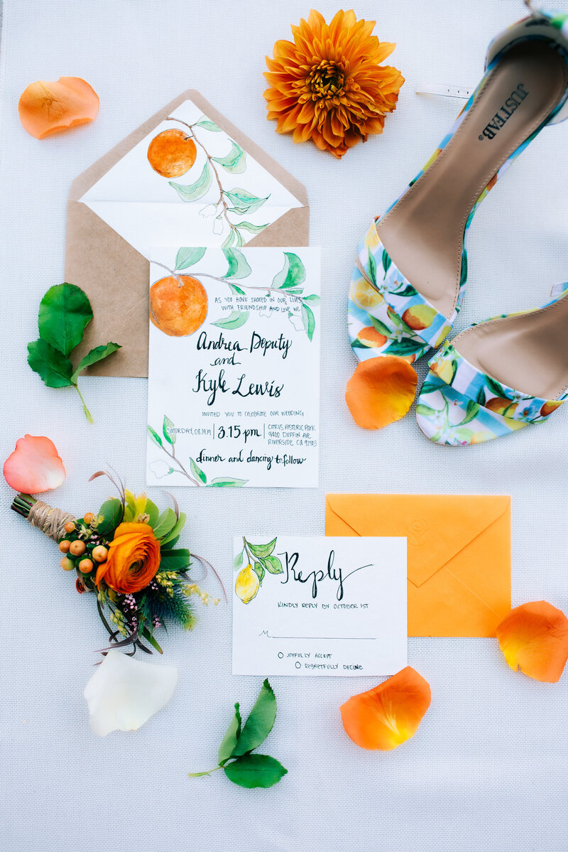 orange and citrus wedding invitation set with matching shoes