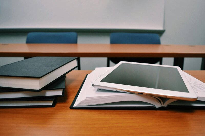 open books and ipad sitting on desk