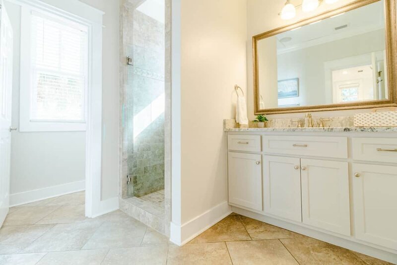 walk in shower and white vanity