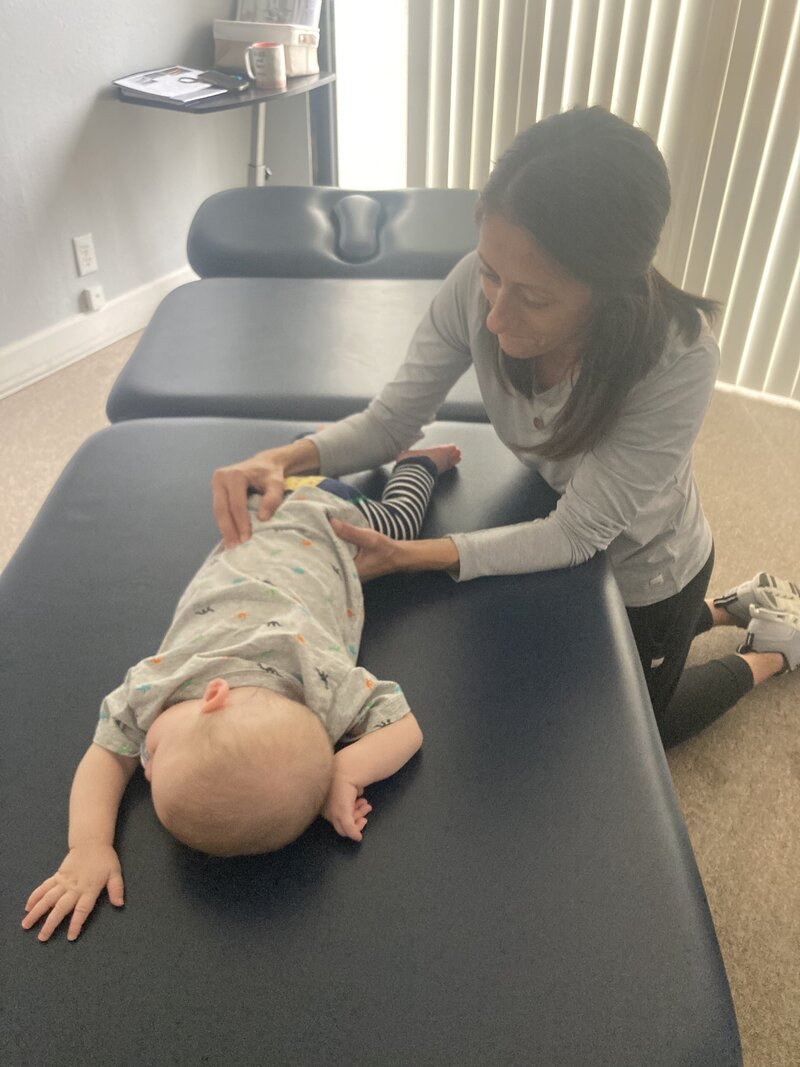 Physical Therapist working on patient's back and torso.