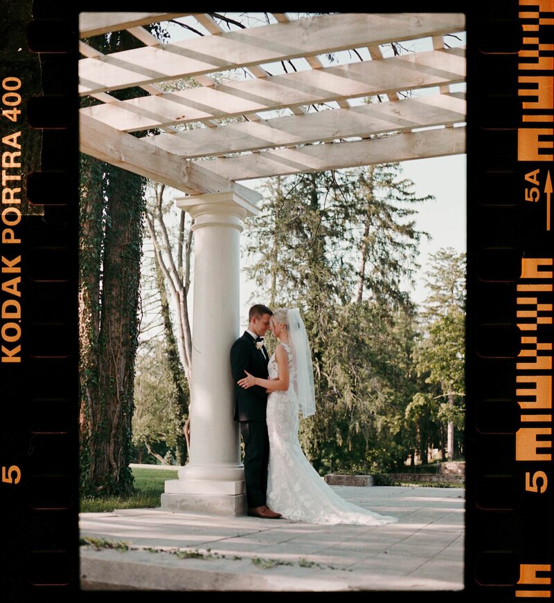 A film strip of a newlywed couple standing close together in an intimate moment 