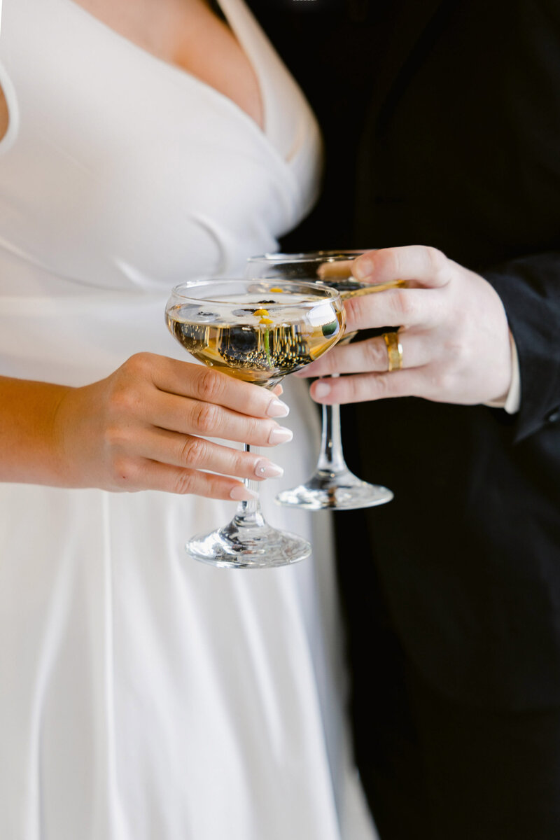 bride and groom toasting with champagne during their wedding