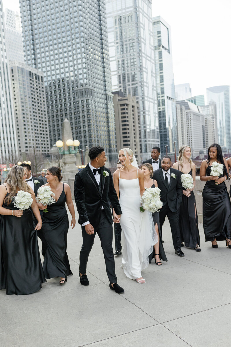 Wedding party laughing and walking together captured by a Madison Wedding Photograher.