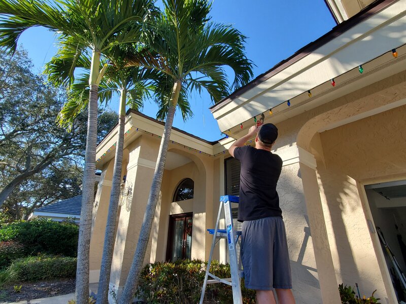 Hanging Christmas lights on a Tampa home