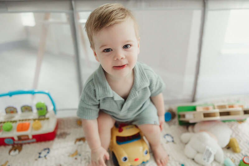 Toddler at home playing with his toys taken during a documentary portrait session. 