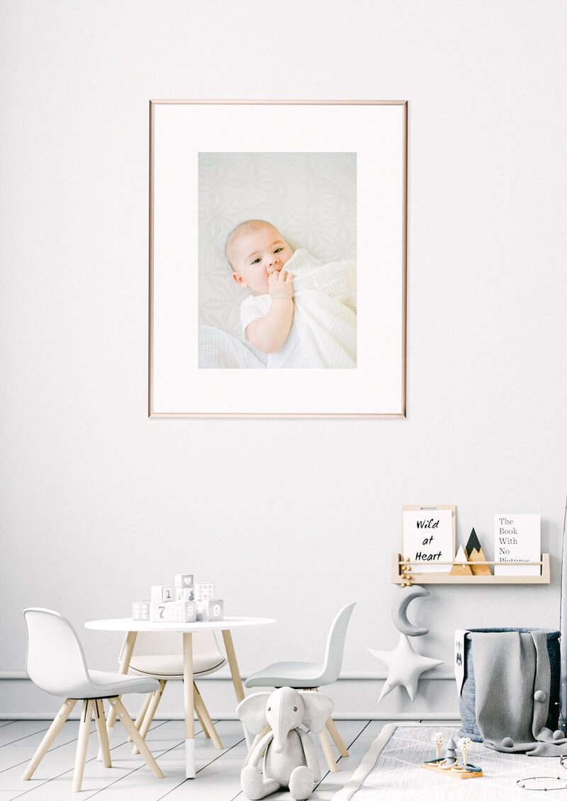 white and gray baby nursery with framed modern photography