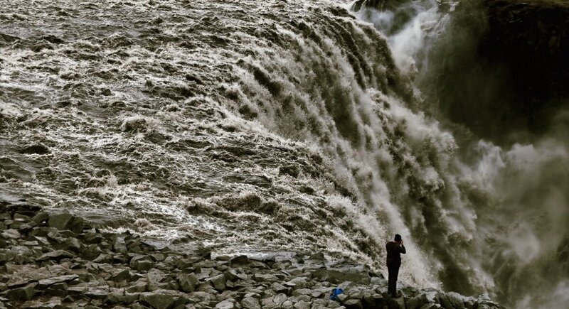 Light Shifter Studios takes pictures next to a waterfall on a trip to Iceland. 