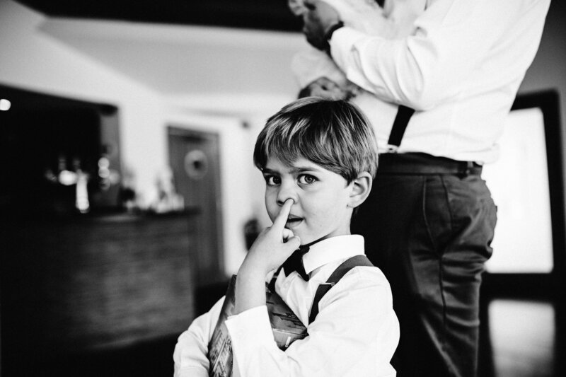 Black and white photo of child getting ready for wedding ceremony
