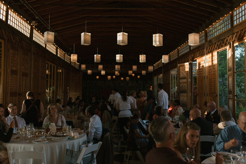 editorial photo of wedding reception dinner with moody lighting