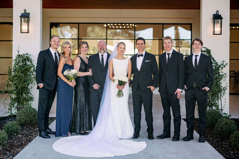 Image of brides family with the bride and groom at the center