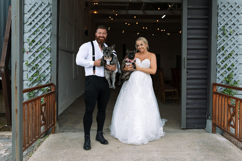 Liv&Wayne-bride and groom standing holding their dog