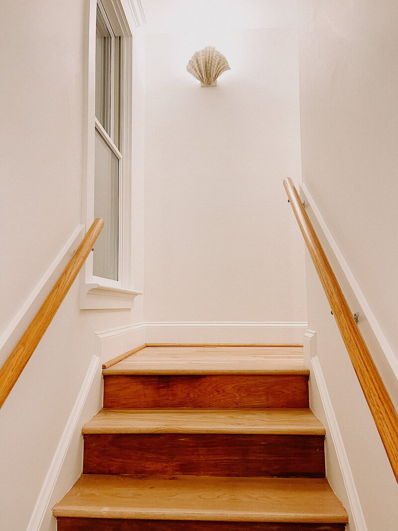 white stairwell with wood floors