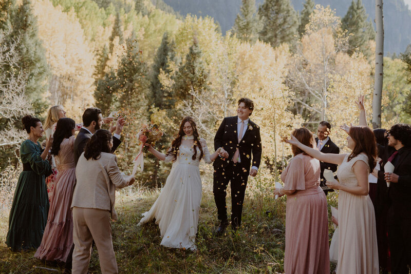 Family throws leaf petals to celebrate elopement