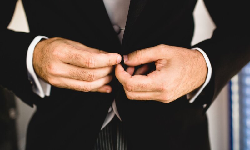 man-buttoning-suit