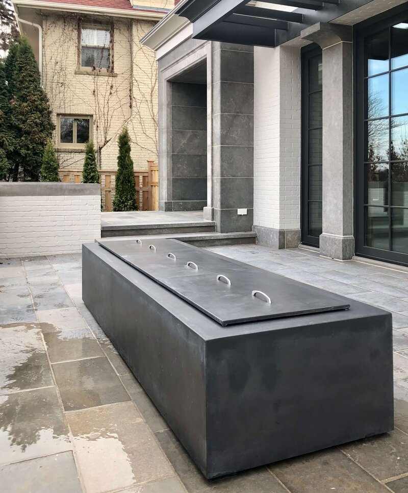 Extra large rectangular concrete fire pit with concrete cover in luxury home