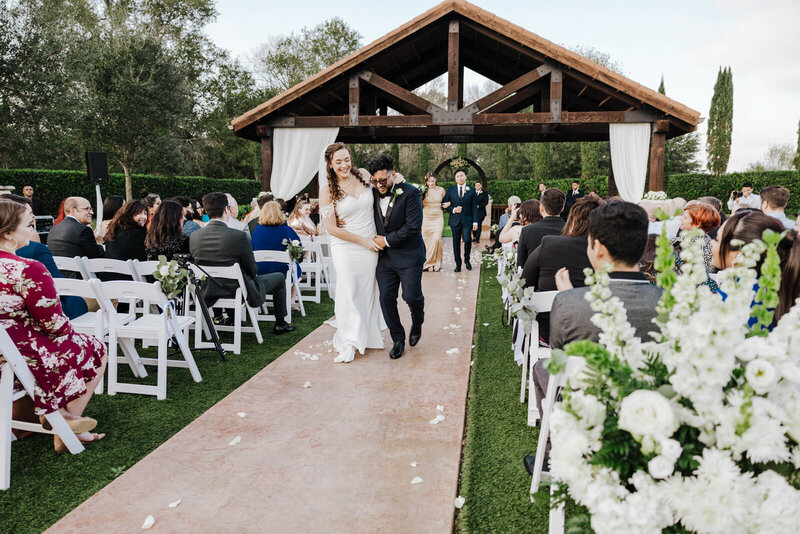 Bride watching groom perform during wedding ceremony in Orlando, photographed by Evoke Wonder Photography