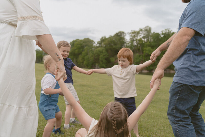 A family of six plays ring around the rosey together at Wing Deer Park in Johnson City, TN. 