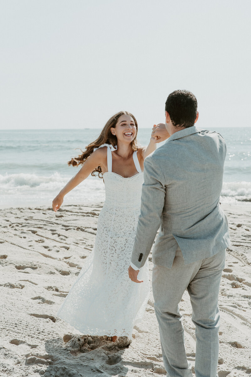 Bride and groom dancing on beach at California elopement