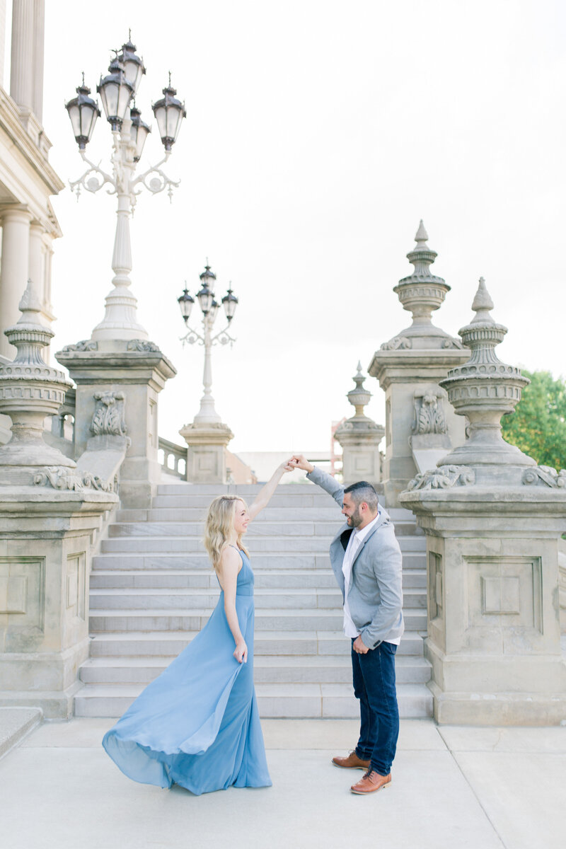 Lauren and Mike share a romantic dance on the steps of the Lansing capital building, Lansing Michigan engagement session, photo by Cynthia Mae Photography Lansing Wedding Photographer