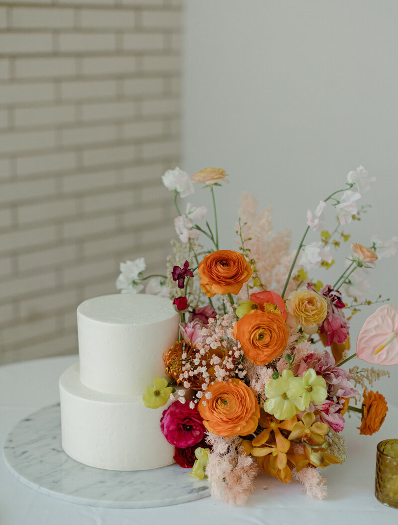 Elegant wedding party lounge with modern floral installation and curated furniture, showcasing Austin event styling and floral artistry.