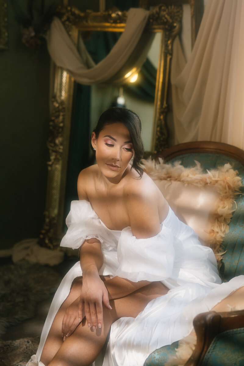 Bride sitting on a vintage couch 