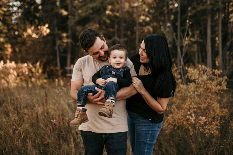 Mother and father holding toddler