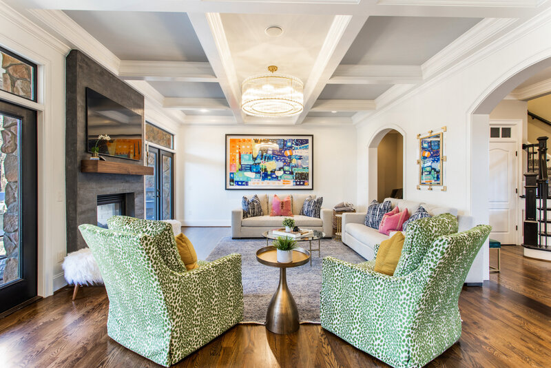 White living room with colorful accent furniture
