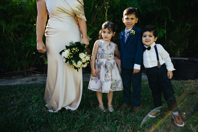 Bride standing with three kiddos in an unposed portrait