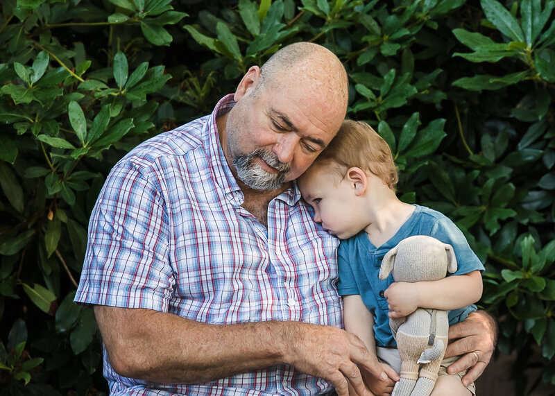 Grandparent and grandkid cuddling in a NJ park.