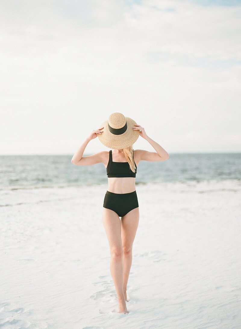 woman on beach with hat