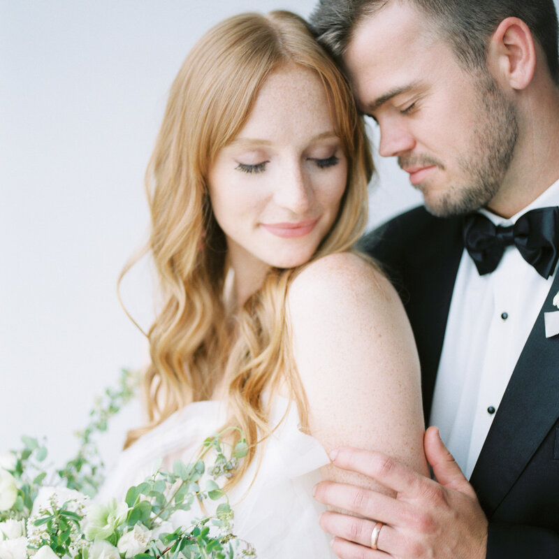 A bride and groom embrace with eyes closed by Birmingham wedding photographer Kelsey Dawn Photography