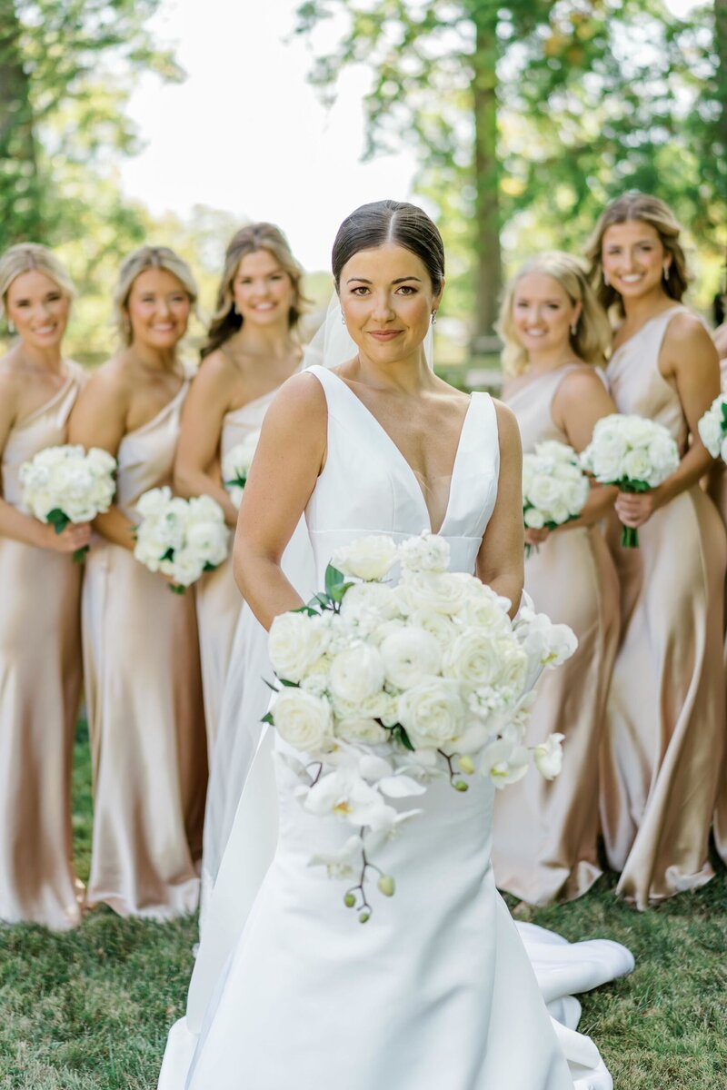 Reception tables decorated with florals, candles, and table settings