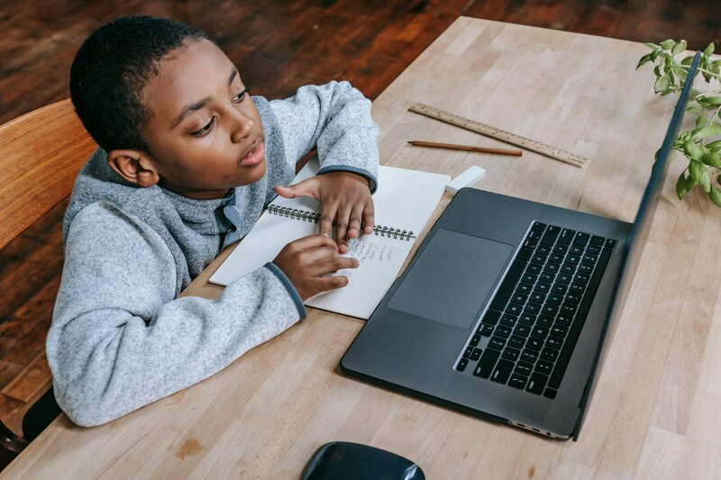 Student working by himself using his laptop