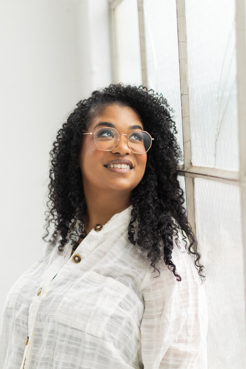 Personal branding photo of Alexa Luckenbach, founder of Alexa Lucky Creative, smiling and working as a web designer for women entrepreneurs