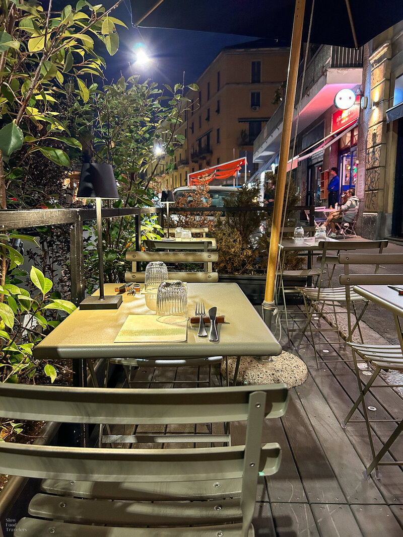 Outdoor patio dining at Denis Pizza di Montagna in Milan, Italy
