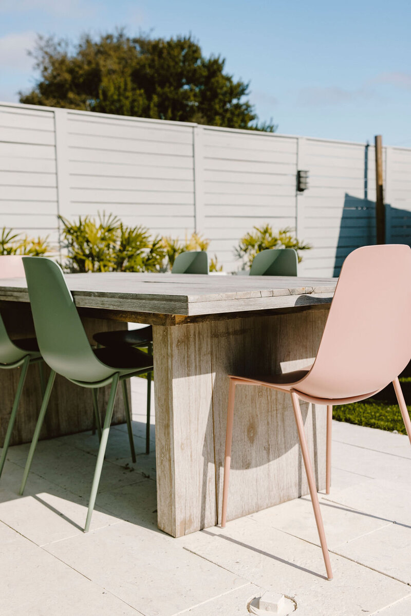 outdoor dining table and colorful chairs