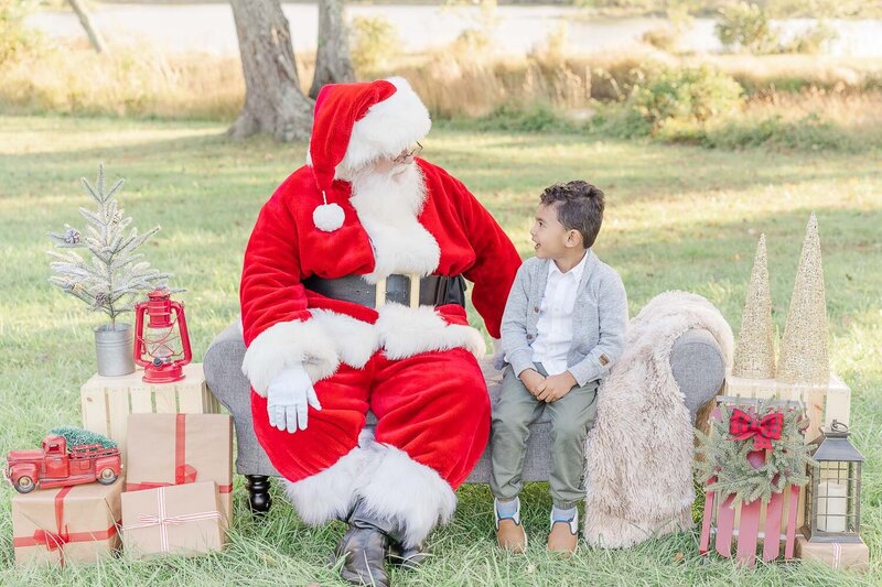 boy talking to Santa during Christmas mini session in Fairfax County, VA