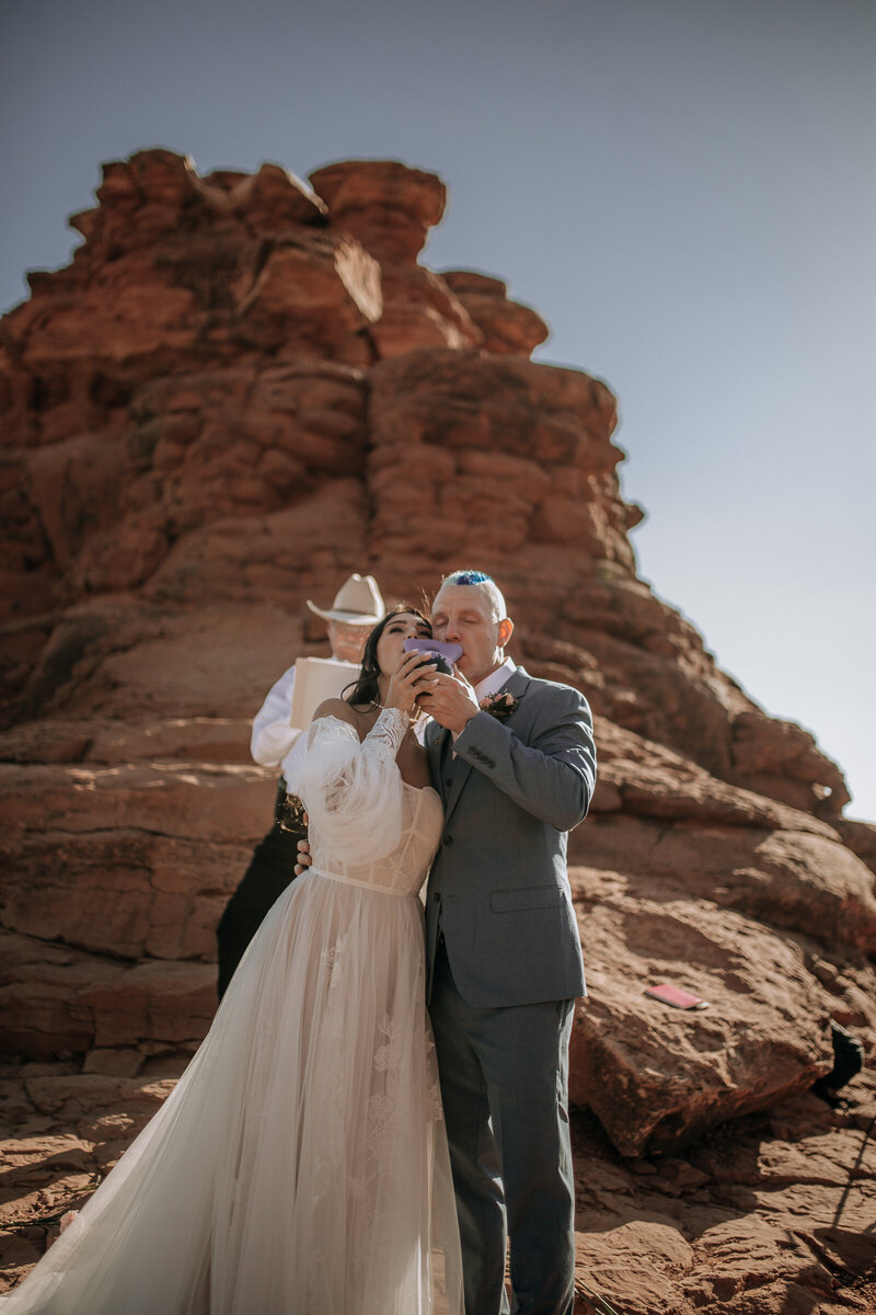 drinking from their wedding vase for sedona elopement native american tradition