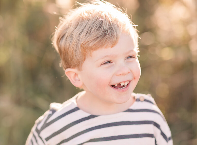toddler boy with toothless grin